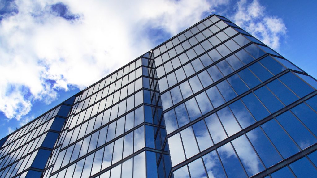 Glass office building against the sky